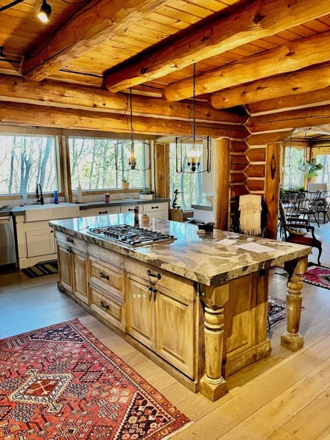 Chefs kitchen with large custom granite island just off the great room
