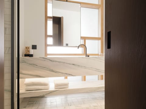 Deluxe Suite, 1 King Bed | Bathroom | Shower, rainfall showerhead, slippers, towels