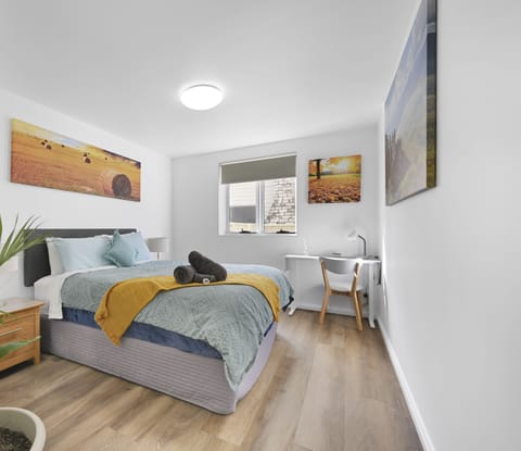 Bedroom with built in wardrobe and workspace area.