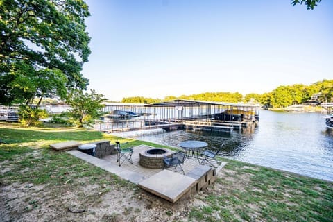 Relax by the lakeside fire pit with peaceful views of the dock and cove.