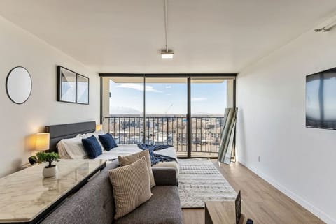 Wake up to stunning city views from this cozy studio featuring a plush bed, sofa seating, and floor-to-ceiling windows 🌇🛏️✨