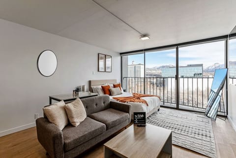 Wake up to stunning mountain views in this cozy studio with a plush bed, sofa lounge, and floor-to-ceiling windows 🌄🛋️