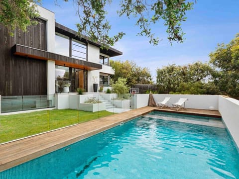 Private pool with sun deck and landscaped outdoor area