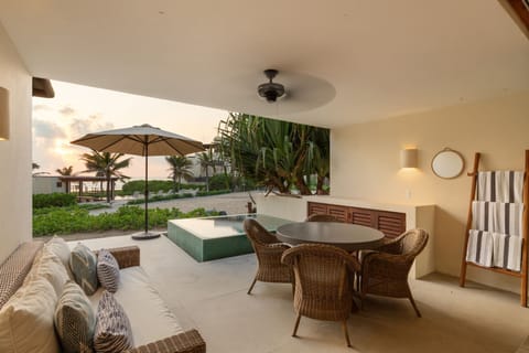 Enjoy ocean breezes in this serene outdoor space, featuring a cozy seating area and a private plunge pool.