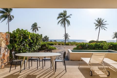 Relax on the shaded patio with stunning beachfront views, perfect for enjoying morning coffee or sunset cocktails.