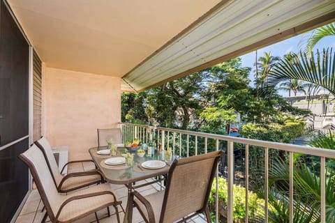 Private furnished lanai with outdoor seating overlooking lush tropical greenery.