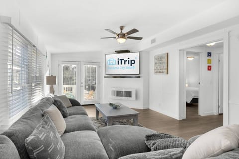 The cozy living area offers a large screen tv and electric fireplace