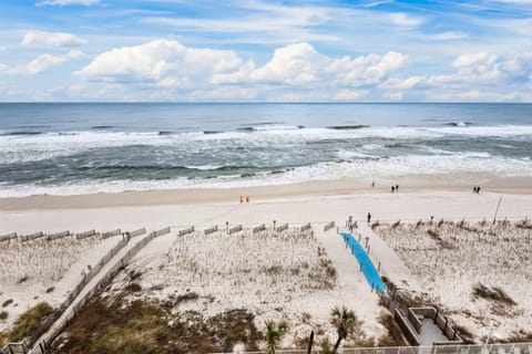 A breathtaking view from the 8th-floor balcony of the condo, overlooking the pristine white sandy beach and the sparkling turquoise waters of the Gulf of Mexico.       