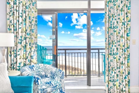 Wake up to stunning oceanfront sunrise views from your private balcony overlooking the beach, sparkling Atlantic Ocean, and tropical resort pools at this Myrtle Beach getaway.