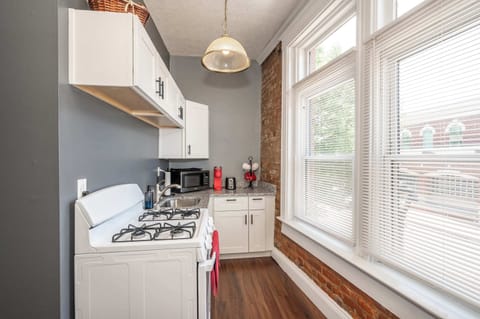Enjoy the comforts of home & historic exposed brick of the kitchen