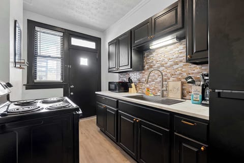 The sleek kitchen offers ample storage & every home comfort