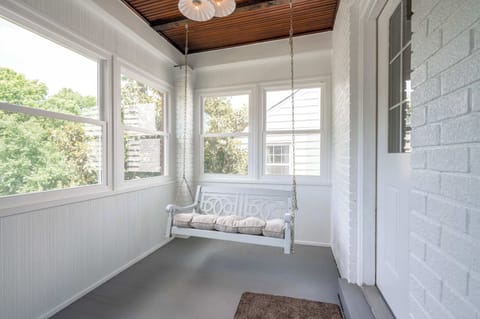 The sunroom porch swing is the perfect spot for relaxing with a book