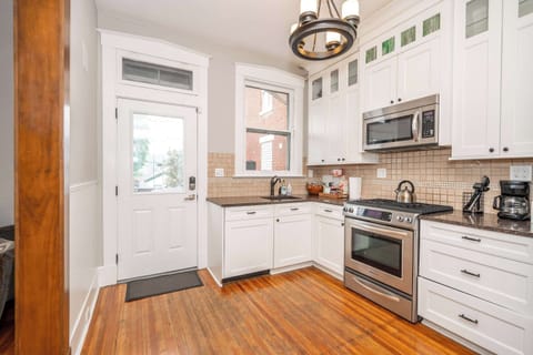 The chic kitchen offers ample space & all the comforts of home