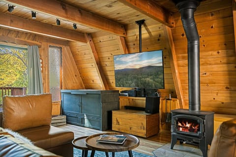 Living room space featuring a wood burning fireplace.
