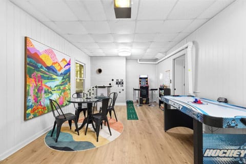 Game room garage with 2 multi-player arcades, air hockey, foosball, card table