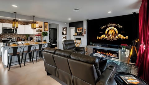 Cinematic magic on leather recliners, 100" Smart TV & Yamaha surround sound. 