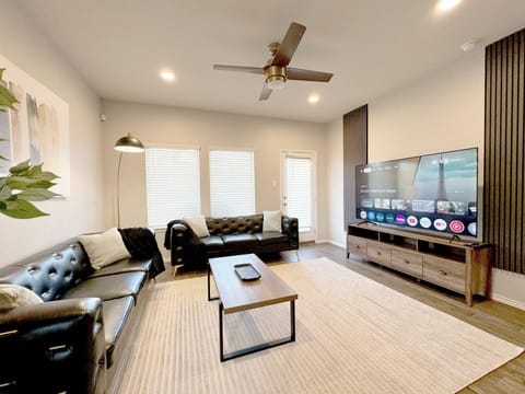 Spacious living room with 75" 4K TV and plenty of seating space