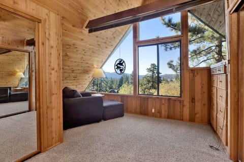 Peaceful cabin bedroom with plush bedding, and beautiful views—ideal for restful nights, cozy mornings, and a relaxing mountain escape.