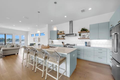 The kitchen is stocked with upscale appliances and cookware essentials