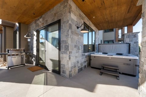 Patio with hot tub and grill