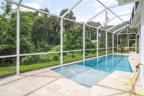 The screened outdoor pool where you can have a quick dip and enjoy the private backyard  and fresh air.