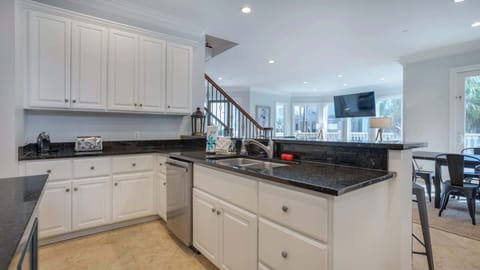 Experience the joy of cooking in this beautifully designed kitchen, complete with high-end appliances and generous counter space. The inviting bar seating creates a social atmosphere, making it easy to host gatherings while whipping up your favs!