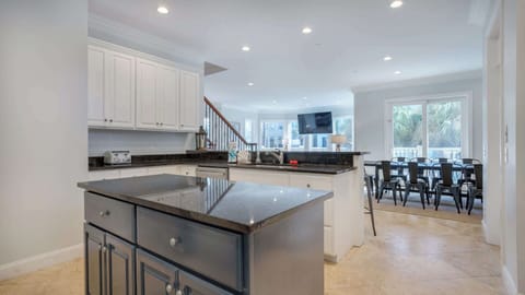 Step into this fully equipped kitchen, designed for both cooking and entertaining. Featuring modern appliances and ample counter space, it’s perfect for preparing meals while enjoying the company of friends and family at the convenient bar seating.