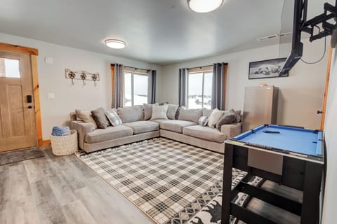 Open living room with large sectional, soft textures, and space to relax.
