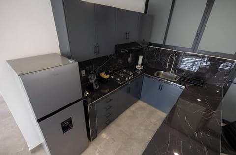 Deluxe Studio, 2 Bedrooms | Private kitchen | Cookware/dishes/utensils, dining tables