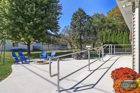 Handicap ramp to the home. Patio with dining table and firepit
