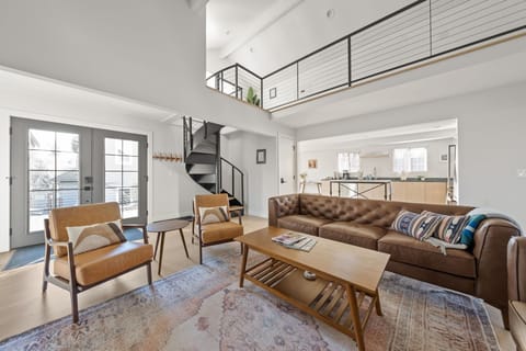 Bright loft-style living room with soaring ceilings and stylish seating