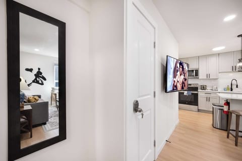 A minimalist corner featuring a large mirror for added elegance and functionality.