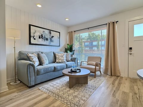 An elegant living area in Downtown Birmingham that blends modern design, natural light, and cozy touches for the perfect stay.