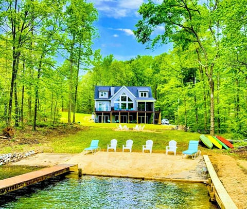 Lakefront - Your own slice of the cove: a private sandy beach, dock, and Adirondack chairs on the lawn waiting for the day to begin.