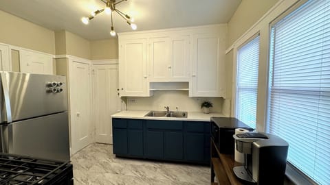 Fully equipped kitchen with dishes, glasses, silverware, and cookware. 
