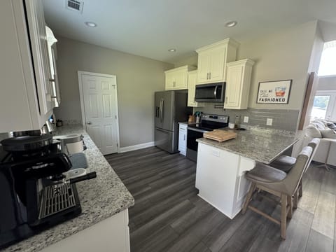 Full kitchen with bar height seating.