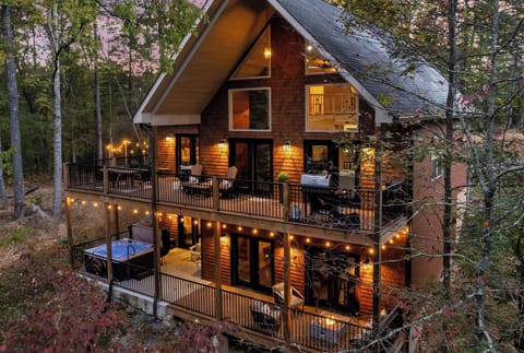 Outdoor amenities like wood fire pit, fire table, hot tub, and oversized decks.