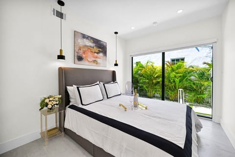 Bright bedroom with garden views and elegant, modern decor. Wine not included.