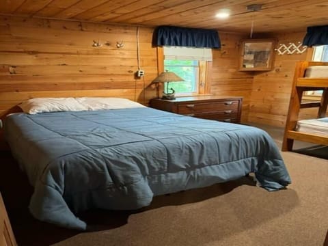 Bedroom with double bed and twin bunk beds