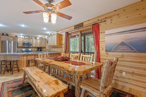 Dining and kitchen area with an outdoor patio to enjoy a morning coffee while submerged in the sounds of the forest.
