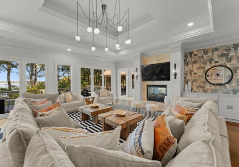 Main Level Family room with huge sectional, sliders to deck, full bar area & TV. 