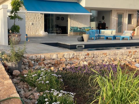 Garden, front of villa and pool