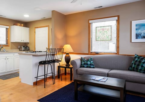 The rear guest house boasts a kitchen, living area, bathroom, and bedroom