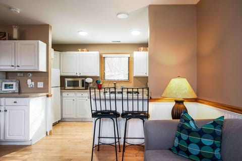 The rear guest house boasts a kitchen, living area, bathroom, and bedroom