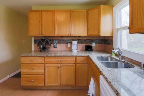 The cozy kitchen is well-equipped and offers ample storage/counter space