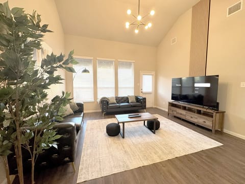 14ft ceiling living room with 75" 4K Smart TV