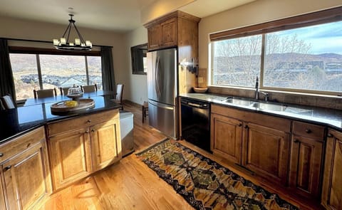 Open kitchen is large, provides lots of space, windows and natural light