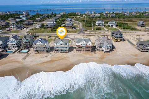 This aerial view showcases Sun Runner's prime oceanfront location and proximity to the beach.