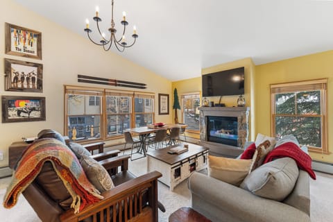 Unwind by your cozy fireplace in this inviting living space, complete with comfortable seating and mountain-themed decor.