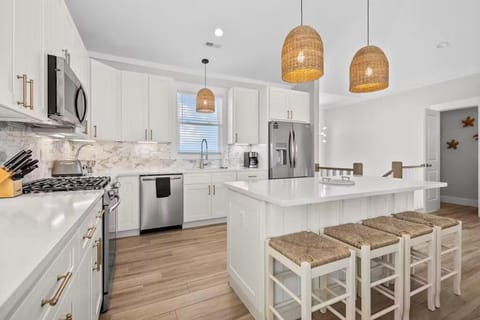 Chef’s kitchen with gas stove and large island with additional seating